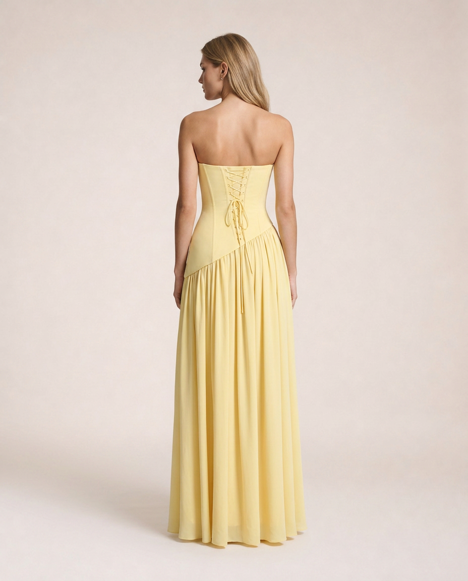 Limone di Amalfi Maxi Dress back view featuring an adjustable lace-up corset back, sculpted bodice and flowing full-length skirt in soft lemon yellow, inspired by the effortless elegance of the Amalfi Coast