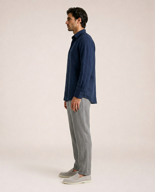Ravello navy linen shirt side profile styled with grey linen trousers and beige loafers