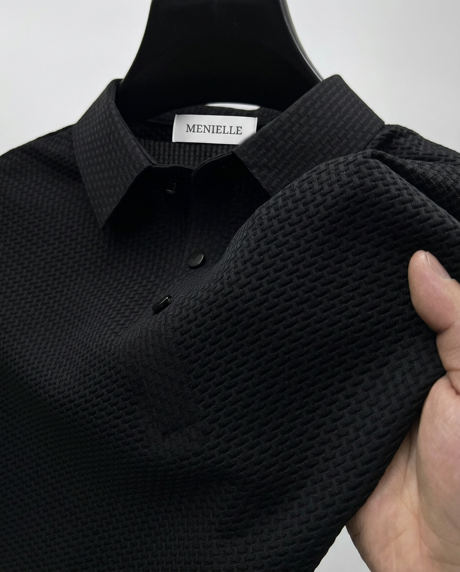Vinicius black polo shirt close-up showing textured fabric and button collar