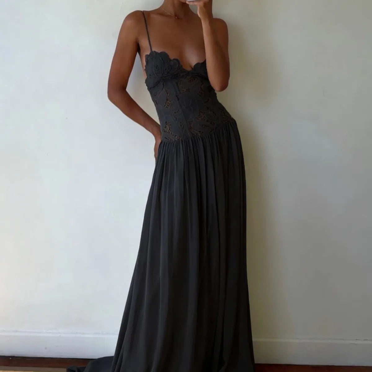 Customer wearing Roséa Noir Maxi Dress indoors with flowing black skirt