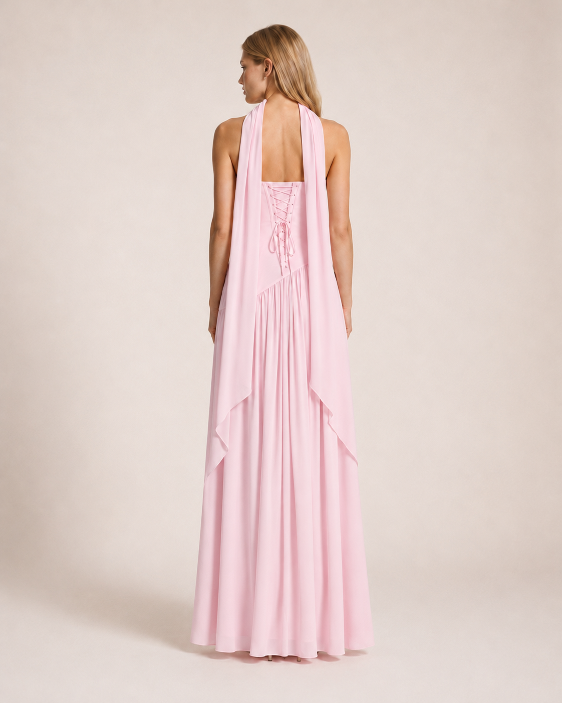 Luna Rosa Maxi Dress back view featuring a lace-up corset back, flowing scarf detail and full-length skirt in soft blush pink
