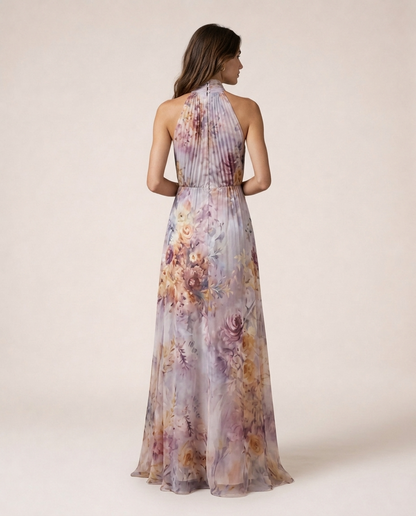 Rosea Maxi Dress back view with pastel floral print, halter neckline and flowing full-length skirt