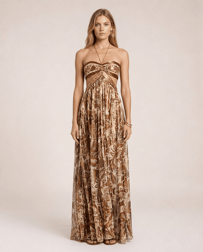 Terra di Siena Maxi Dress featuring a brown Mediterranean-inspired print, bandeau neckline, open back with halter tie and flowing full-length skirt