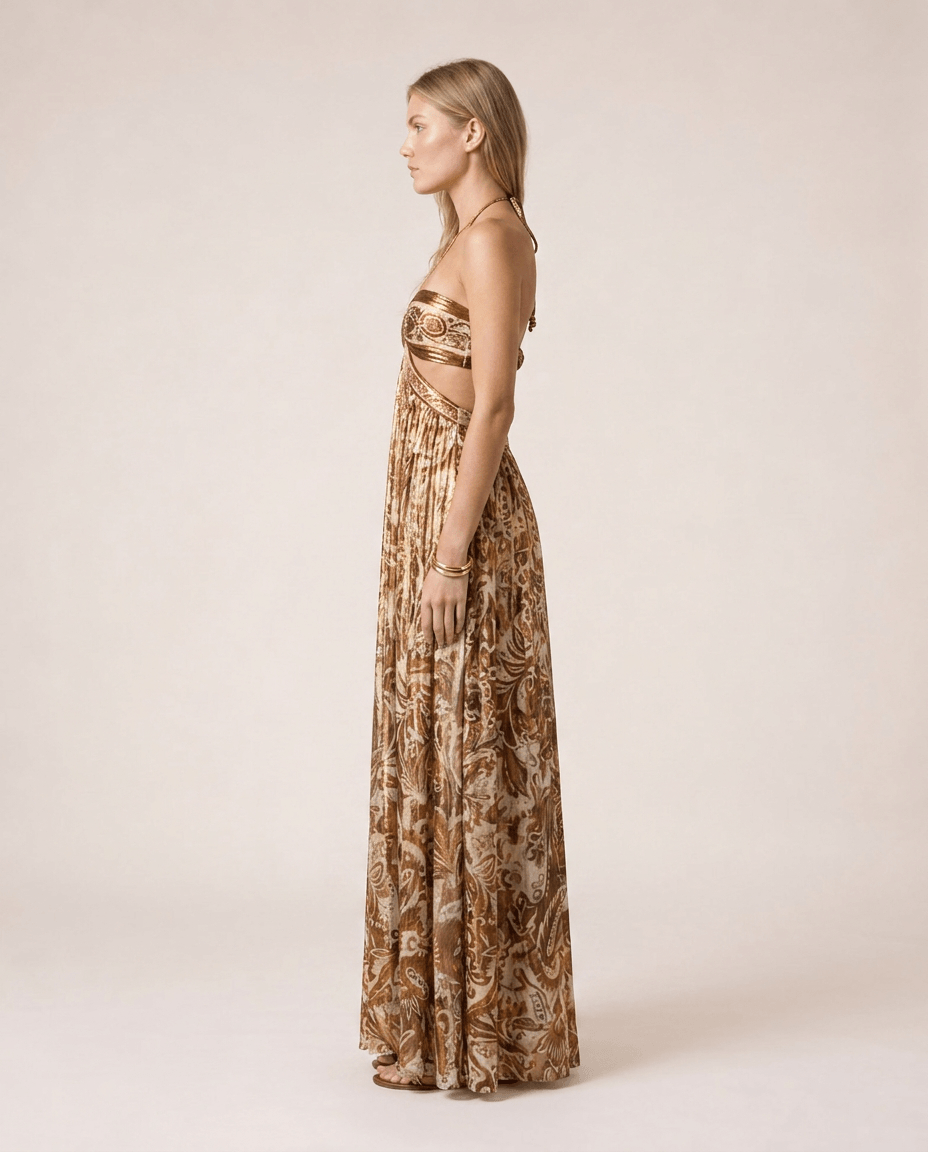 Terra di Siena Maxi Dress Side View featuring a brown Mediterranean-inspired print, bandeau neckline, open back with halter tie and flowing full-length skirt