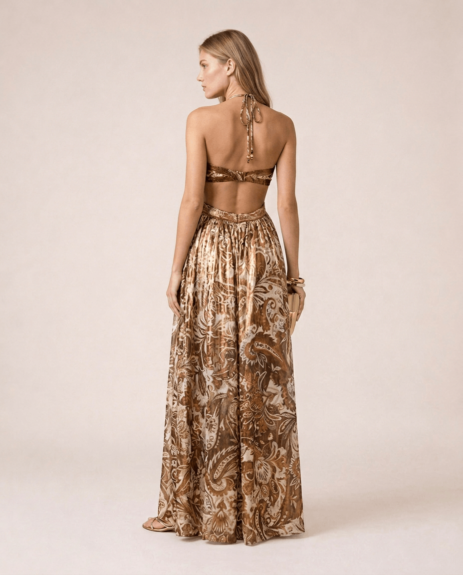 Terra di Siena Maxi Dress back view featuring a brown Mediterranean-inspired print, bandeau neckline, open back with halter tie and flowing full-length skirt