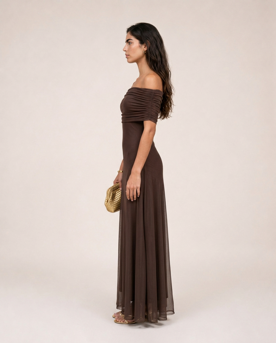 Side view of the Alessia Maxi Dress in chocolate brown with a fitted bodice and flowing sheer maxi skirt