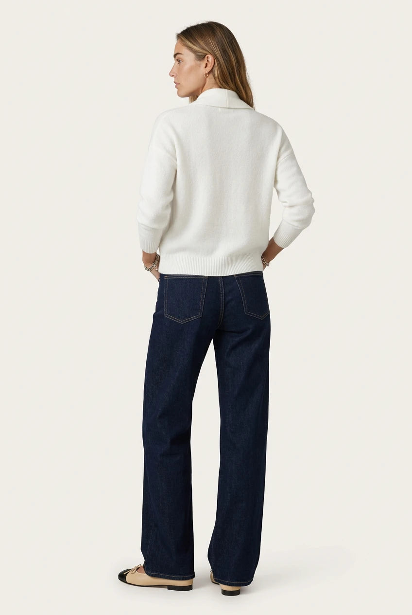 Back of the Menielle Antonine Sweater in white: knit sweater with a shawl collar and ribbed hem, with dark jeans